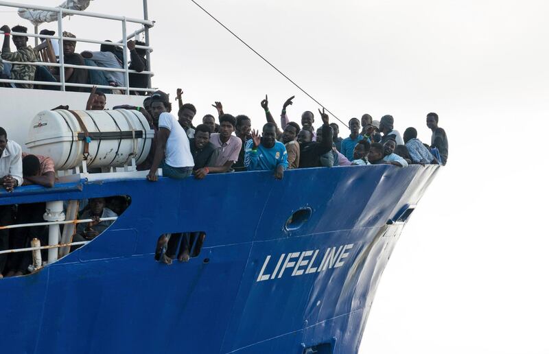 In this photo taken on Thursday, June 21, 2018, migrants wave from aboard ship operated by the German NGO Mission Lifeline. Italy's interior minister says Malta should allow a Dutch-flagged rescue ship carrying 224 migrants to make port there because the ship is now in Maltese waters. Salvini said the rescue was in Libyan waters, which Lifeline denies. (Hermine Poschmann/Mission Lifeline via AP)