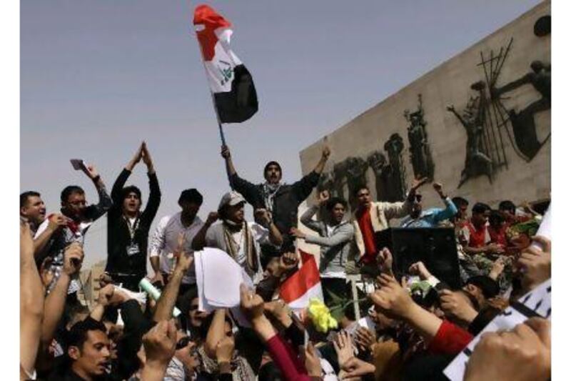 A man waves the Iraqi flag as protesters chant anti-government slogans during a demonstration in Baghdad on Friday.