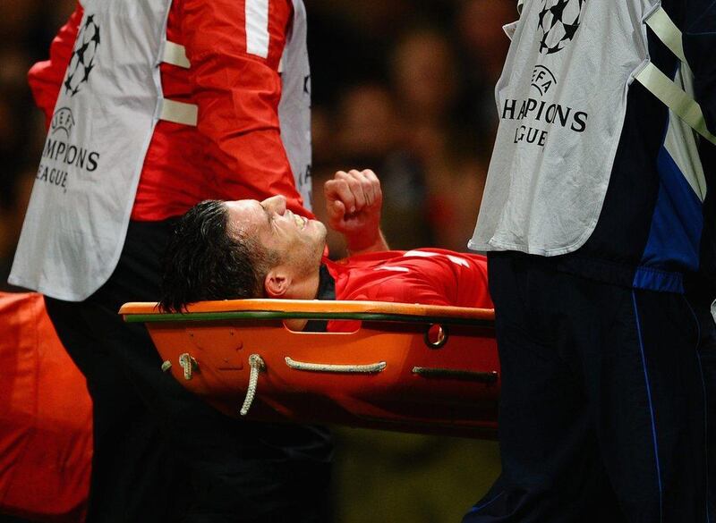 Robin van Persie is stretchered off during the match against Olympiakos on Wednesday. Laurence Griffiths / Getty Images / March 19, 2014