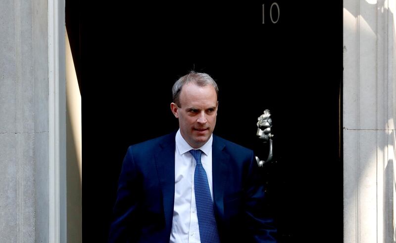 FILE - In this Wednesday April 22, 2020 file photo, Britain's Foreign Secretary Dominic Raab leaves 10 Downing Street, London. Britainâ€™s foreign secretary hinted Sunday, July 19 he may move to suspend the U.K.â€™s extradition arrangements with Hong Kong, and accused Beijing of â€œgross and egregiousâ€ human rights abuses against its Uighur population in Chinaâ€™s western province of Xinjiang. (AP Photo/Frank Augstein, file)