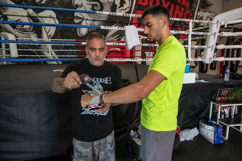 Hamzah Sheeraz gets his hands wrapped up trainer Rickey Funez at the Real Boxing Only Gym. Antonie Robertson / The National