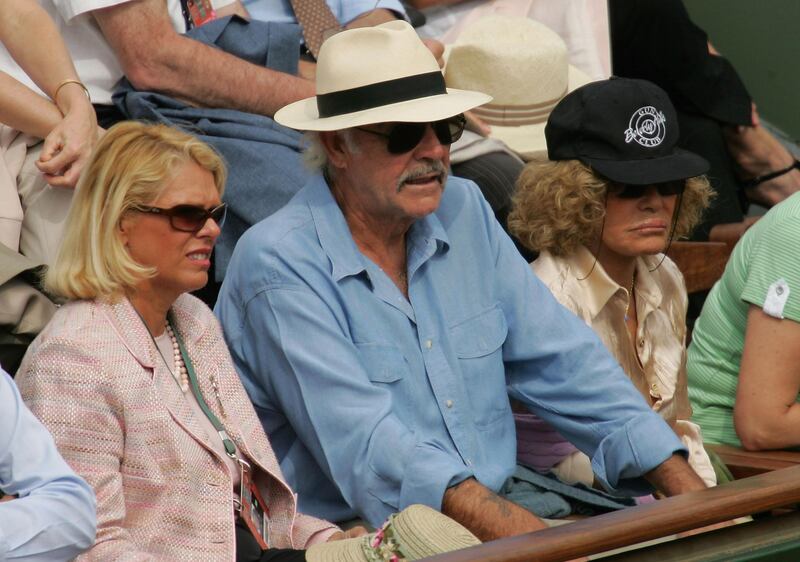 PARIS - JUNE 01:  Sean Connery and his wife Micheline Roquebrune look on as Tommy Robredo of Spain plays against Nikolay Davydenko during the quarter-final match of Russia during the tenth day of the French Open at Roland Garros on June 1, 2005 in Paris, France.  (Photo by Clive Mason/Getty Images)