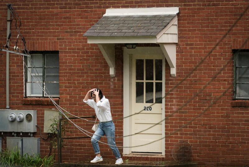 A resident makes a run to the car in Winston-Salem om North Carolina. AP Photo