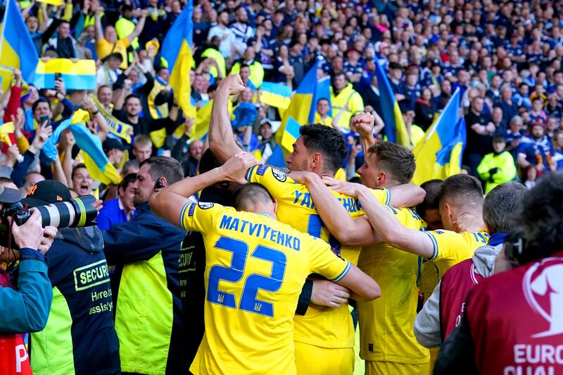 Yaremchuk celebrates with Ukraine fans. PA