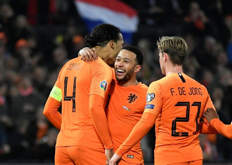 Van Dijk celebrates scoring their fourth goal with Depay and De Jong. Reuters