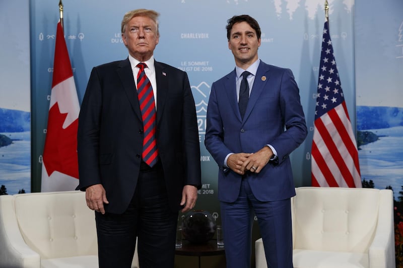 FILE - In this June 8, 2018 file photo, U.S. President Donald Trump meets with Canadian Prime Minister Justin Trudeau at the G-7 summit in Charlevoix, Canada. For the first time in decades, one of the world's most durable and amicable alliances faces serious strain as Canadians _ widely seen as some of the nicest, politest people on Earth _ absorb Donald Trump's insults against their prime minister and attacks on their countryâ€™s trade policies. (AP Photo/Evan Vucci, File)