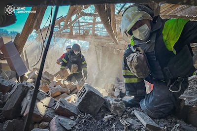 Ukrainian rescuers at the site of a missile attack in Mykolaivka, in the Donetsk region, where three people were killed in Russian air strike. AFP
