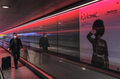 LONDON, ENGLAND - JUNE 01: An airline passenger walks through an underpass between terminal buildings at Heathrow Airport on June 1, 2021 in London, England. Heathrow's Terminal 3 will now be reserved for direct arrivals from countries on the British government's "red list," from which travelers are subject to a 10-day hotel quarantine. Previously, there was concern about "red list" arrivals queueing in Heathrow terminals alongside travelers from countries with a lower Covid-19 risk profile. (Photo by Chris J Ratcliffe/Getty Images)