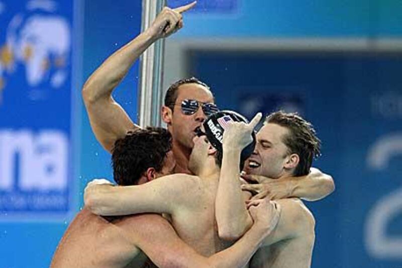 The victorious US team hug after winning the men´s 4x100-metre medley relay yesterday.