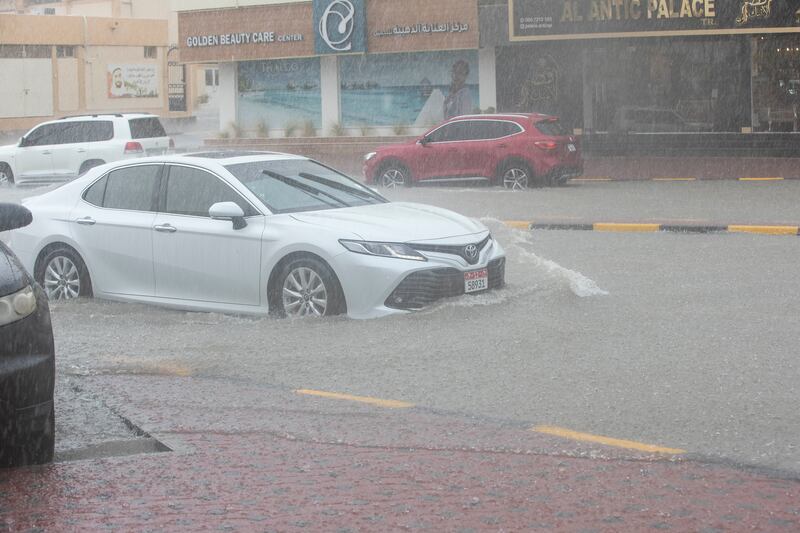 Cars navigate a flooded road in Khor Fakkan, amid heavy rains in the city. Ruel Pableo for The National