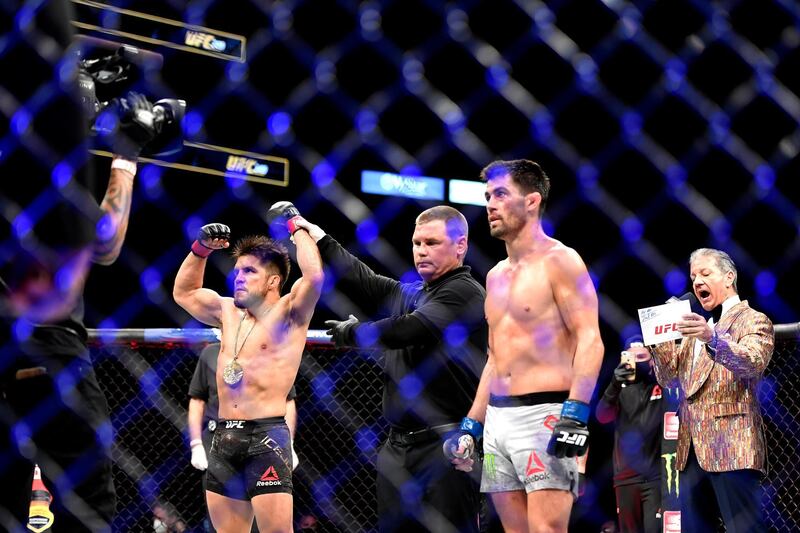 JACKSONVILLE, FLORIDA - MAY 09: Henry Cejudo (L) of the United States celebrates defeating Dominick Cruz (R) of the United States in their bantamweight title fight during UFC 249 at VyStar Veterans Memorial Arena on May 09, 2020 in Jacksonville, Florida.   Douglas P. DeFelice/Getty Images/AFP