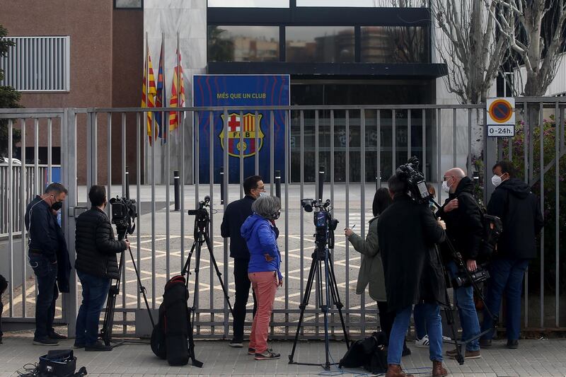 Reporters wait outside FC Barcelona's headquarters as members of Mossos d'Esquadra regional police's economic offences unit raid the offices. EPA