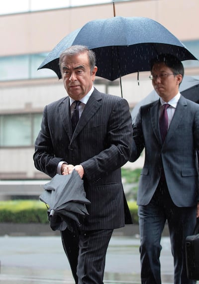 (FILES) In this file photo taken on June 24, 2019 former Nissan Motor Chairman Carlos Ghosn (L) arrives for a pre-trial hearing at the Tokyo District Court in Tokyo. A year after Japan learned with horror that Carlos Ghosn had jumped bail to become the world's most famous fugitive, the fiasco and its repercussions continue to haunt the country. Ghosn was living in a monitored Tokyo apartment awaiting trial on financial misconduct charges when he casually boarded a train to Osaka in western Japan on December 29, 2019 with two accomplices. - TO GO WITH AFP FOCUS "JAPAN-GHOSN-AUTOMOBILE-LEBANON-NISSAN-RENAULT" BY ETIENNE BALMER 
 / AFP / Kazuhiro NOGI / TO GO WITH AFP FOCUS "JAPAN-GHOSN-AUTOMOBILE-LEBANON-NISSAN-RENAULT" BY ETIENNE BALMER 
