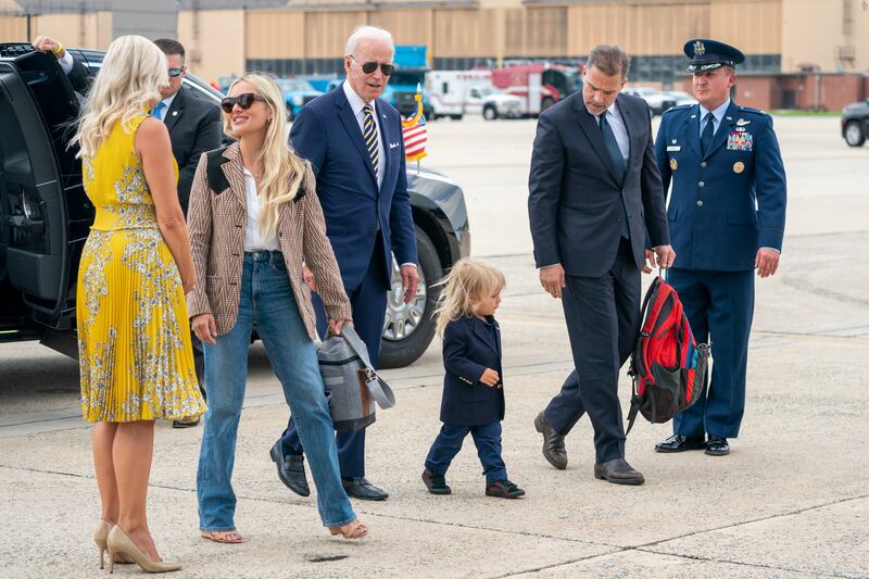 Mr Biden walks with his grandson, son and daughter-in-law Melissa Cohen at Joint Base Andrews, Maryland.  EPA 