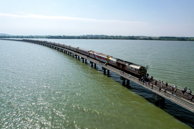 Tourists get off a train after it stops at the middle of Pasak Jolasid Dam in Lopburi province, Thailand. Reuters