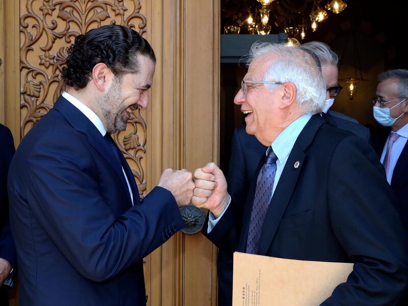 FILE - In this Saturday, June 19, 2021 file photo, released by the Lebanese government, Lebanese Prime Minister-Designate Saad Hariri, left, greets European Union foreign policy chief Josep Borrell with a fist bump, in Beirut, Lebanon. Borrell said Sunday that a struggle for power and strong mistrust is at the heart of the fight between Hariri, named to the post in October, on one side, and President Michel Aoun and his son-in-law Gebran Bassil, who heads the largest bloc in parliament, on the other. (Dalati Nohra/Lebanese Official Government via AP, File)