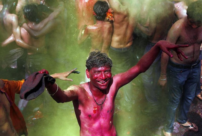 Men dance as coloured powder and water is sprayed on them during Holi celebrations in the northern Indian city of Allahabad. Jitendra Prakash / Reuters