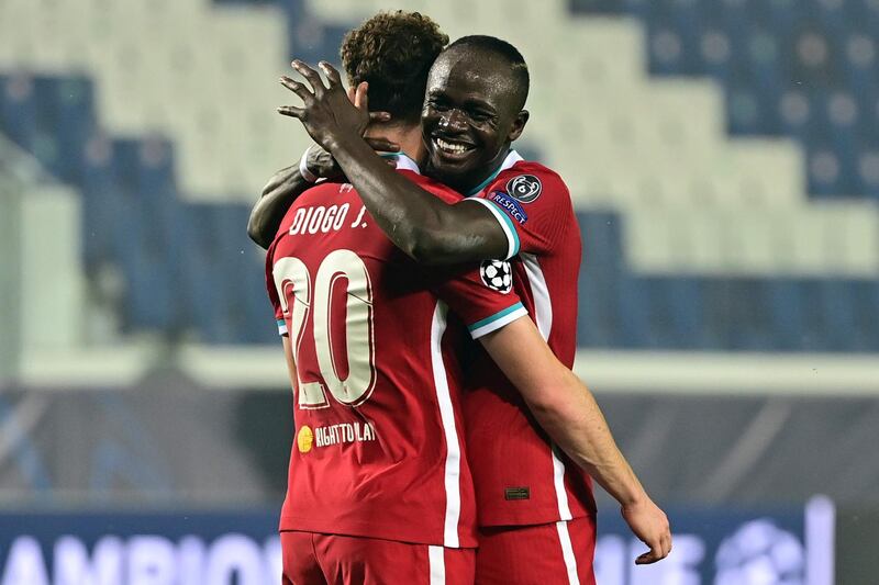 Liverpool's Portuguese striker Diogo Jota is congratulated by Liverpool's Senegalese striker Sadio Mane after scoring. AFP