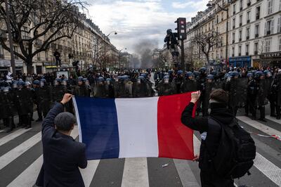 Protesters hold up a French flag during a rally in Paris in March. Getty Images