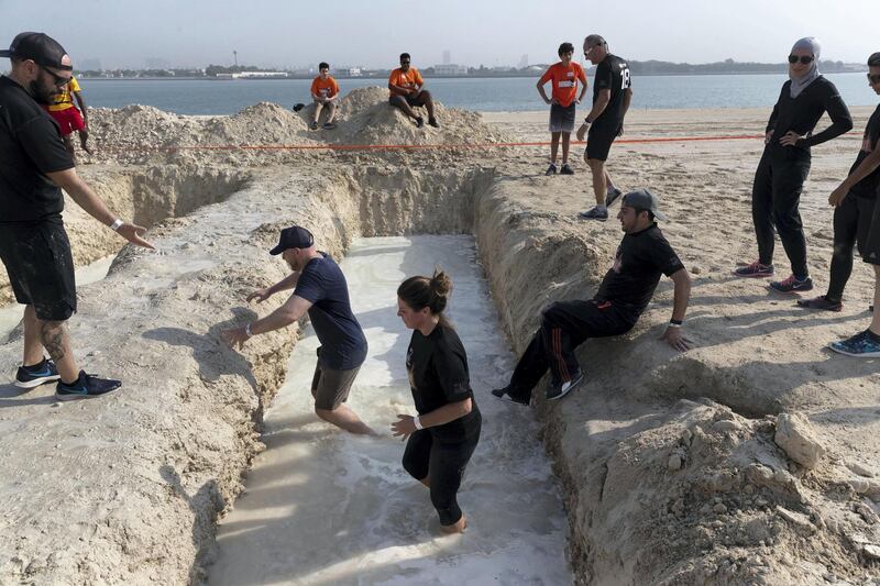 ABU DHABI, UNITED ARAB EMIRATES. 11 OCTOBER 2019. The Tough Mudder sports event held on Hudayriat Island in Abu Dhabi. The main Tough Mudder event challenged dedicated and amateur athletes with a 5km course designed to get participants moving over obstacles and along a dedicated route engineered to build team spirit. (Photo: Antonie Robertson/The National) Journalist: None. Section: National.
