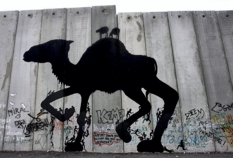 epa01191036 Illusive British graffiti artist named Banksy has painted new works in the West Bank town of Bethlehem and this work of a camel with human figures climbing up and down its legs on 04 December 2007 could be one of his new works. It is executed on a huge cement wall, but not the controversial 'separation barrier,' that protects an Israeli military base inside, on the outskirts of Bethlehem. The works are not signed. These new works are being dubbed 'West Banksy,' and some are painted on the controversial Israeli 'separation barrier,' or wall, that surrounds Bethlehem and cuts its residents off from nearby Jerusalem.  EPA/JIM HOLLANDER *** Local Caption *** 01191036