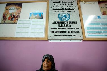 A woman waits for a medical check in the UNWRA health centre in Askar refugee camp in the occupied West Bank on September 1, 2018. AFP