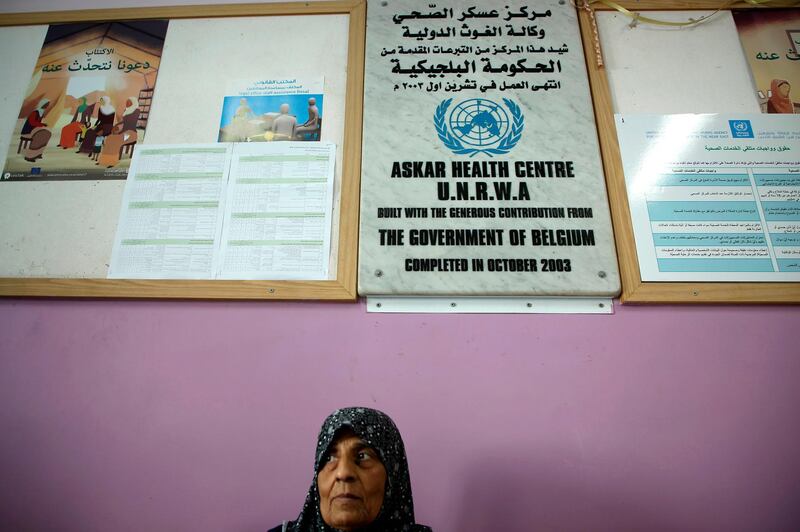 A refugee waits for a medical check in the UNWRA (UN agency for Palestinian refugees) health center of the Asker refugee camp near Balatah, east of Nablus, in the occupied West Bank on September 1, 2018. (Photo by Jaafar ASHTIYEH / AFP)
