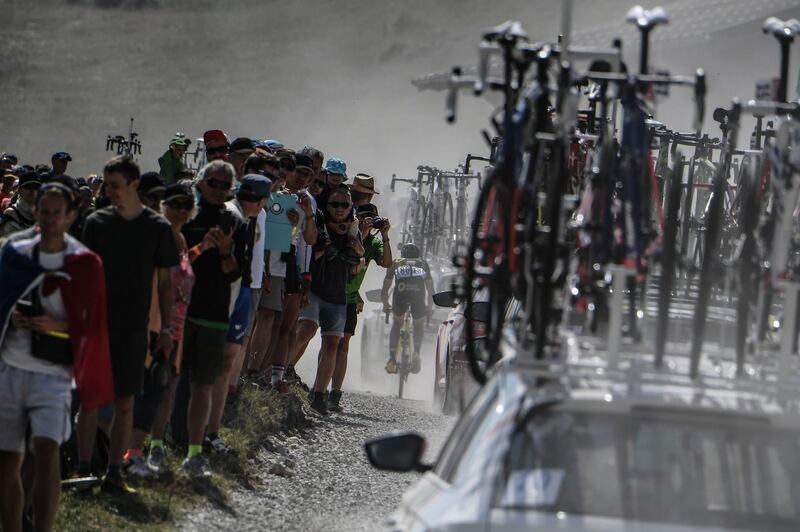 Spectators watch as France's Fabien Grellier, rear, pedals in the ascent of the Plateau des Glieres during the 10th stage of the Tour de France between Annecy and Le Grand-Bornand. Jeff Pachoud / AFP