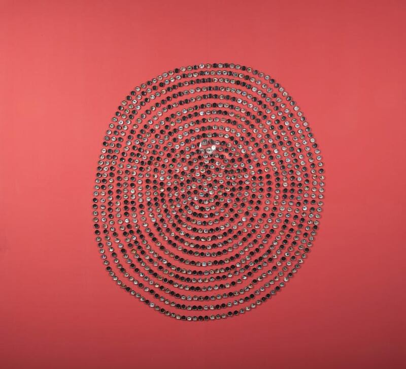Huda Lutfi’s Just Discarded features bottle caps arranged in concentric circles, with photos of eyes of the people she saw on the street. Huda Lutfi / The Third Line