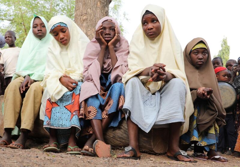 Pupils who escaped from gunmen wait outside their school premises for their parents. The gunmen abducted more than 300 of their fellow pupils at Jangebe Government Girls Secondary School, Zamfara state, Nigeria. EPA