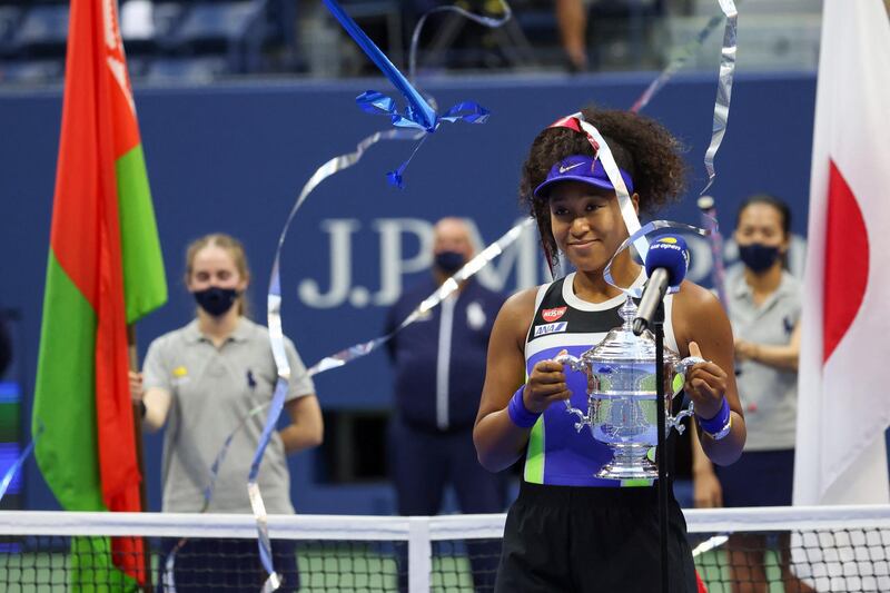 NEW YORK, NEW YORK - SEPTEMBER 12: Naomi Osaka of Japan celebrates with the trophy after winning her Women's Singles final match against Victoria Azarenka of Belarus on Day Thirteen of the 2020 US Open at the USTA Billie Jean King National Tennis Center on September 12, 2020 in the Queens borough of New York City.   Al Bello/Getty Images/AFP (Photo by AL BELLO / GETTY IMAGES NORTH AMERICA / AFP)