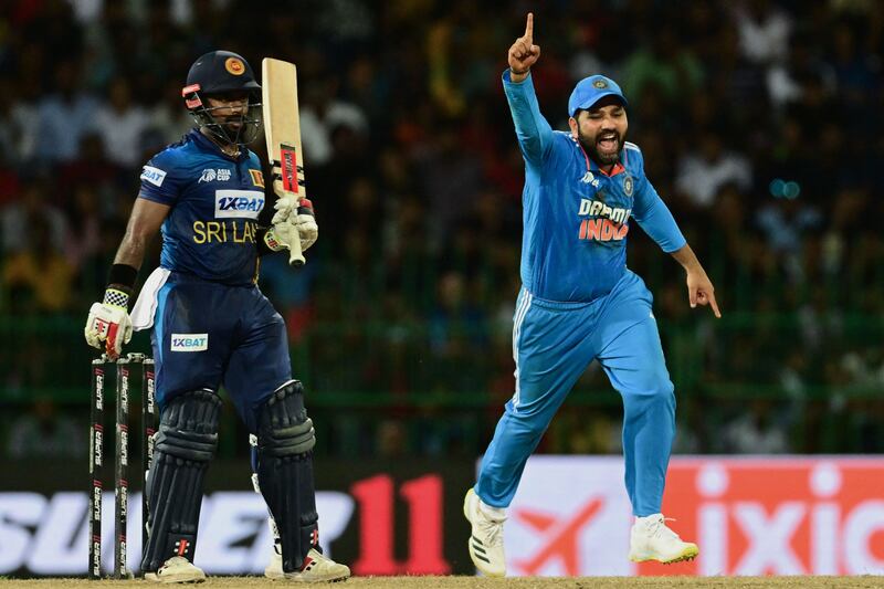 India's captain Rohit Sharma celebrates after the dismissal of Sri Lanka's Charith Asalanka. AFP