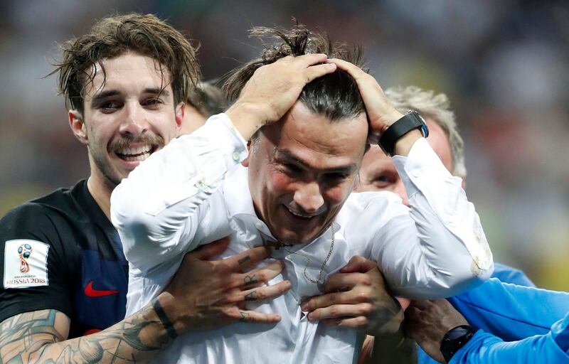 Croatia head coach Zlatko Dalic celebrates with Sime Vrsaljko, left, after his team advanced to the final during the semifinal match between Croatia and England at the 2018 soccer World Cup in the Luzhniki Stadium in Moscow, Russia, Wednesday, July 11, 2018. (AP Photo/Frank Augstein)