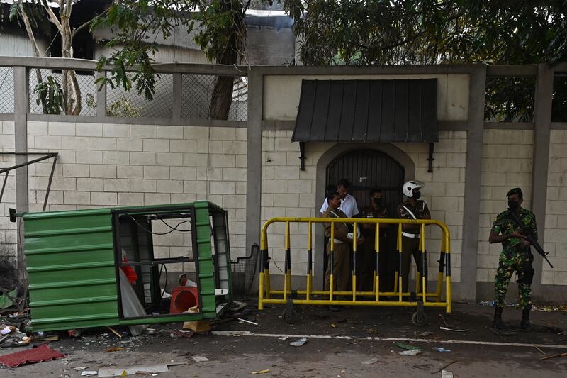 Security personnel guard the home of Sri Lankan Prime Minister Ranil Wickremesinghe in Colombo on Sunday, a day after protesters set it on fire. Photo: AFP