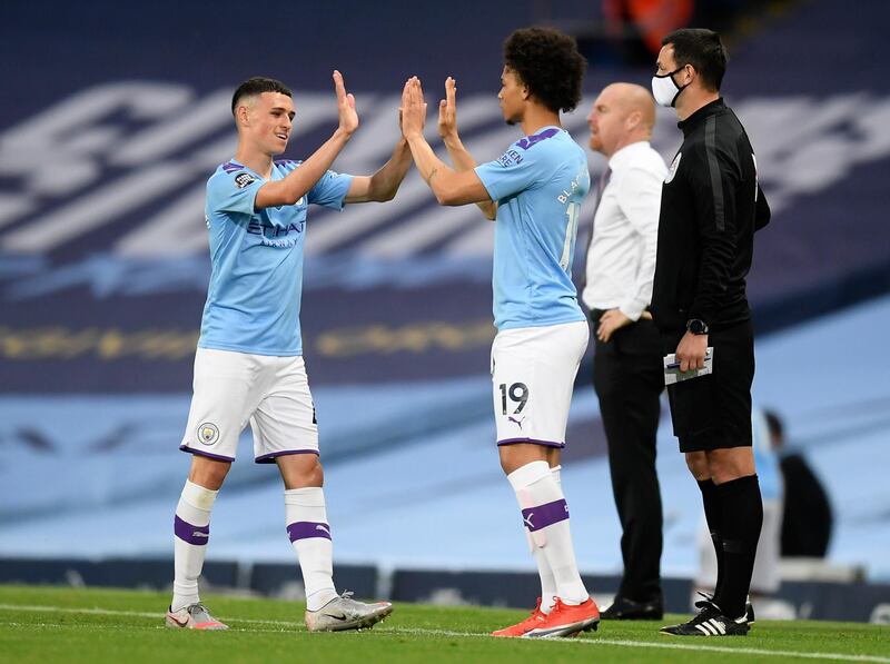 Manchester City's Phil Foden, left, is substituted for Leroy Sane. AP Photo