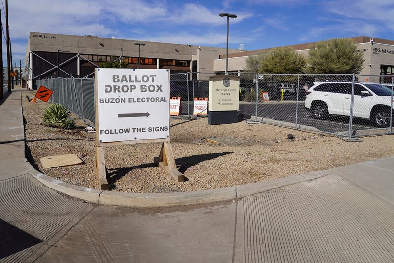 A sign directs voters to drop box location in downtown Phoenix. Willy Lowry / The National