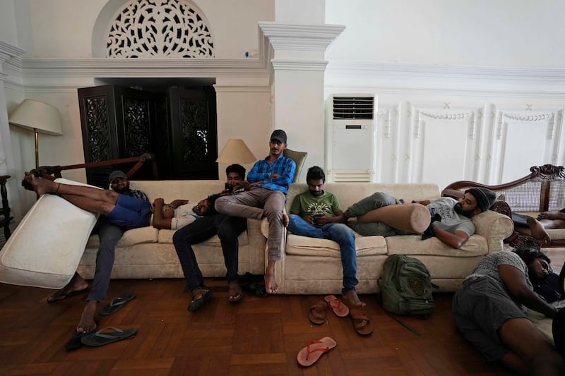 Protesters rest on sofas in the prime minister's residence. AP