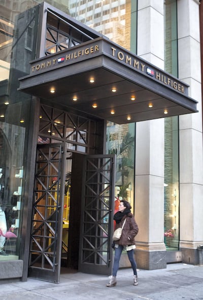 A pedestrian walks by the Tommy Hilfiger flagship store on Manhattan's Fifth Avenue in New York, U.S., on Monday, March 15, 2010. Phillips-Van Heusen Corp. agreed to buy Tommy Hilfiger BV from private-equity firm Apax Partners LP for 2.2 billion euros ($3 billion).  (Photo by Ramin Talaie/Corbis via Getty Images)