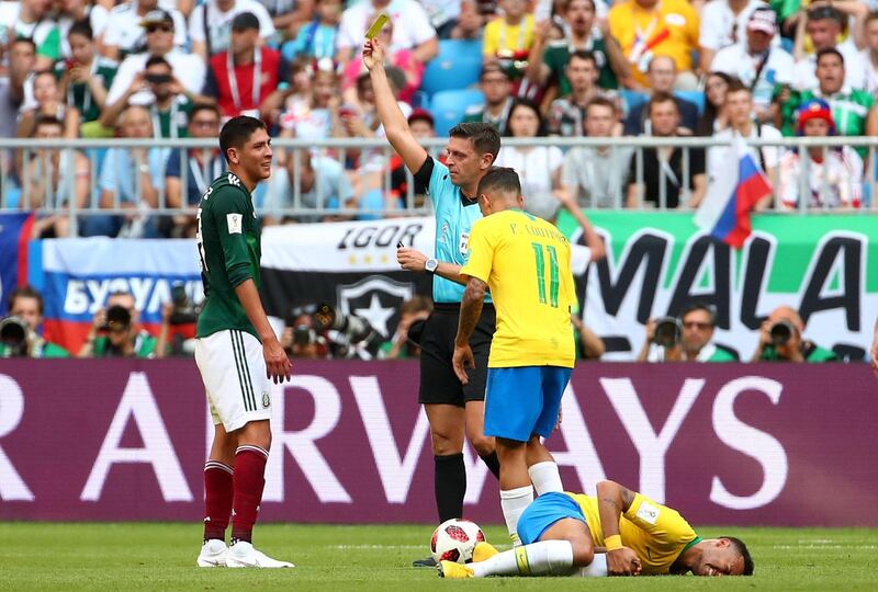 Mexico's Edson Alvarez is shown a yellow card by referee Gianluca Rocchi as Brazil's Neymar reacts. Michael Dalder / Reuters