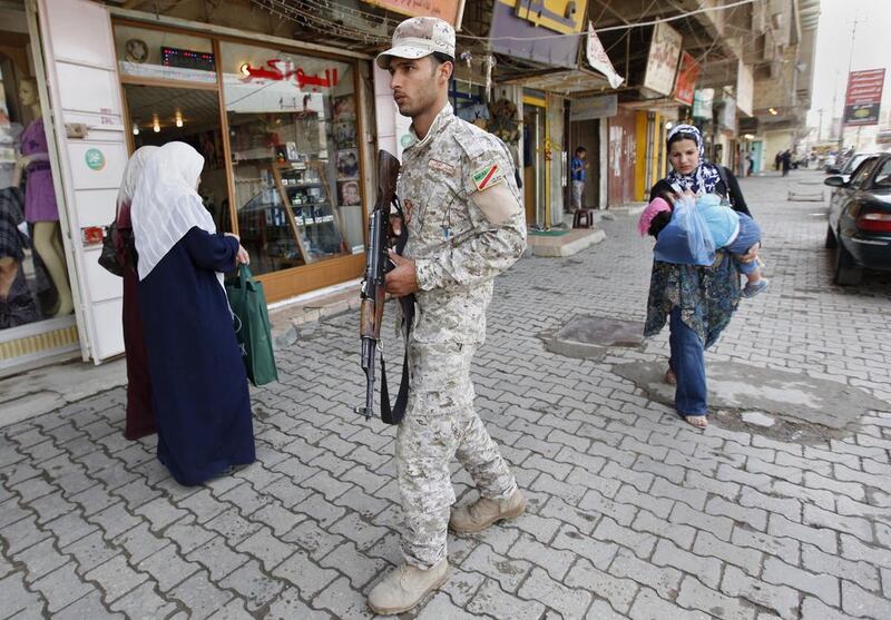 Iraq's new prime minister Haidar Al Abadi is scheduled to send parliament legislation on Tuesday aimed in part at reprising the Sunni Awakening movement – forces that fought Al Qaeda alongside the US military in Anbar province a decade ago. In this file picture from April 3, 2010, an Iraqi Awakening council member is seen patrolling in the Azamiyah area of north Baghdad. Hadi Mizban/AP Photo