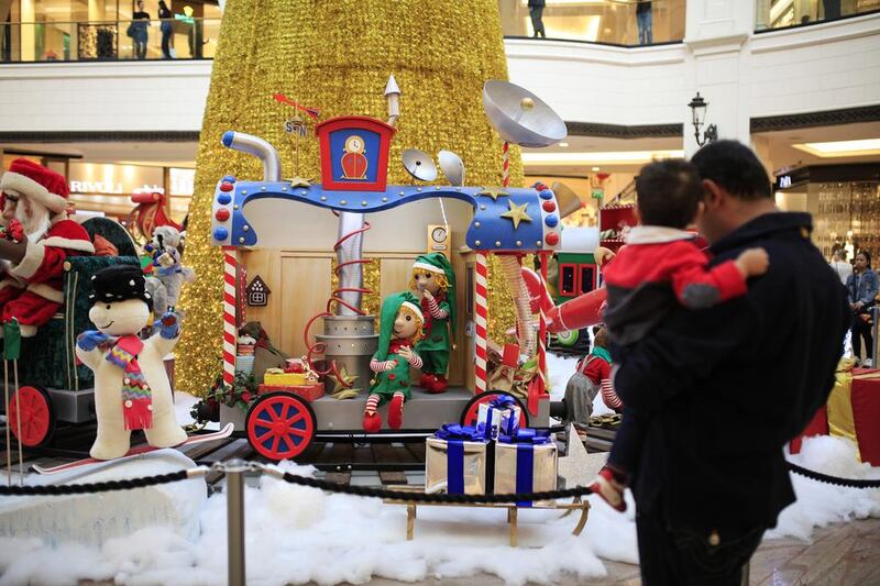 Visitors admire the Christmas displays at the Mall of the Emirates in Dubai. Sarah Dea / The National