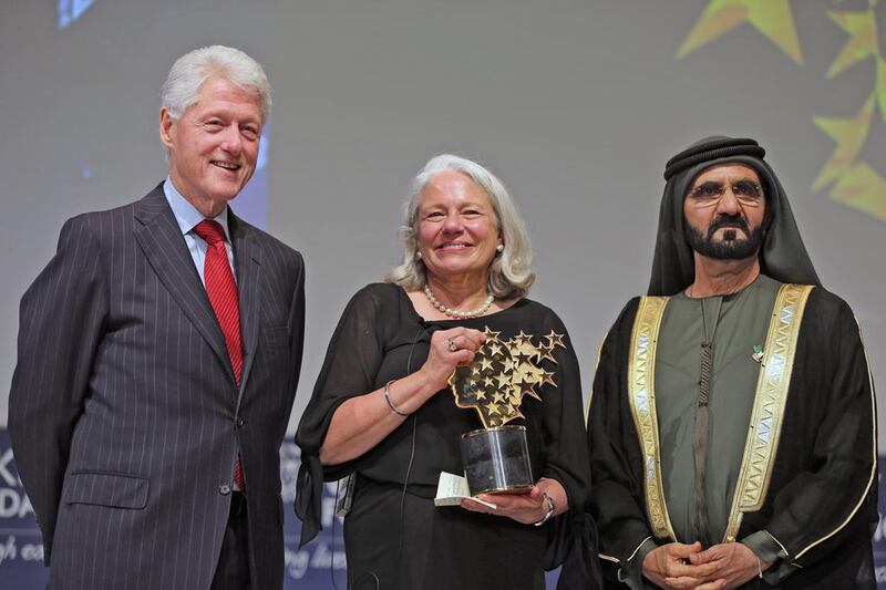 Nancie Atwell, a teacher from Southport, Maine, US, receives the 2015 Global Teacher Prize from Sheikh Mohammed bin Rashid, Vice President and Ruler of Dubai, and former US President Bill Clinton in Dubai. Atwell has been teaching since 1973 and founded the Centre for Teaching and Learning in Southport. Kamran Jebreili / AP