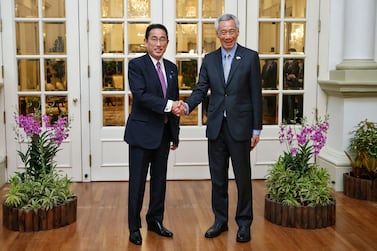 This picture provided by The Straits Times taken and released on June 11, 2022 shows Japan's Prime Minister Fumio Kishida (L) shaking hands with Singapore's Prime Minister Lee Hsien Loong during a state visit to the Istana in Singapore.  (Photo by FELINE LIM  /  The Straits Times  /  AFP)  /  - Singapore OUT  /  -----EDITORS NOTE --- RESTRICTED TO EDITORIAL USE - MANDATORY CREDIT "AFP PHOTO  /  THE STRAITS TIMES  /  FELINE LIM " - NO MARKETING - NO ADVERTISING CAMPAIGNS - DISTRIBUTED AS A SERVICE TO CLIENTS  - NO ARCHIVE