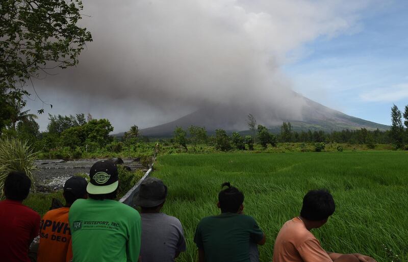 Residents watch as Mayon volcano spews ash at a tourist spot near Cagsawa ruins in Daraga in Albay province, south of Manila. Ted Aljibe / AFP Photo