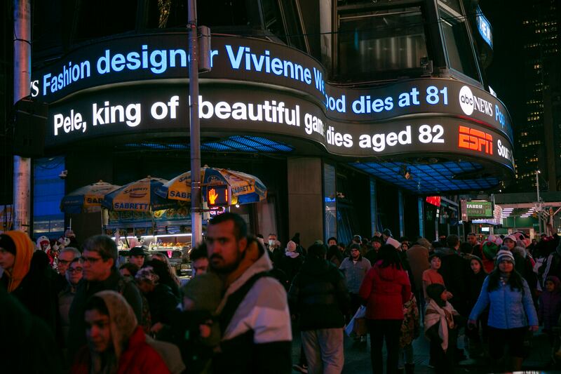 An electric news headline ticker in Times Square announces the death of Pele. AP