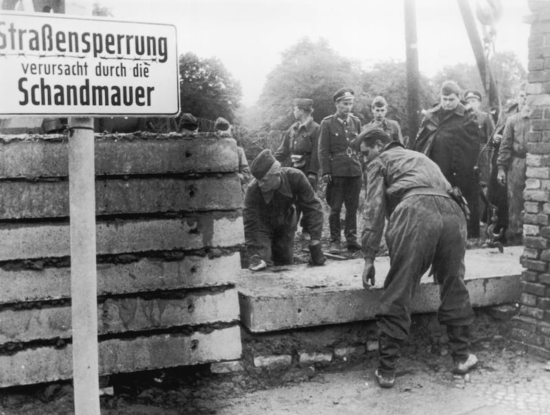 1961:  (FILE PHOTO)  Saturday, August 13th will celebrate 50 Years Since East German Troops Sealed The Border Between East And West Berlin
Please refer to the following profile on Getty Images Archival for further imagery. 
http://www.gettyimages.co.uk/EditorialImages/News?parentEventId=120436353
and
http://www.gettyimages.co.uk/Search/Search.aspx?EventId=120437101&EditorialProduct=Archival
And Also
In Profile: The Berlin Wall 
http://www.gettyimages.co.uk/Search/Search.aspx?EventId=120436548&EditorialProduct=Archival

Soldiers building the Berlin Wall as instructed by the East German authorities, in order to strengthen the existing barriers dividing East and West Berlin in 1961 in Berlin, Germany.  (Photo by Keystone/Getty Images) *** Local Caption ***  3246564.jpg