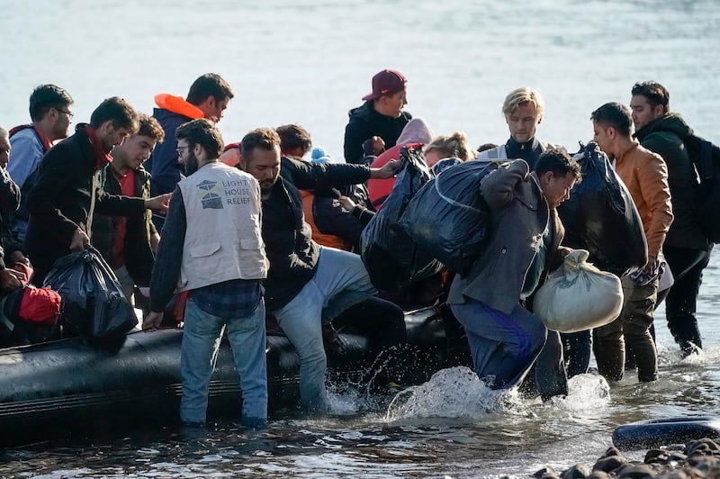 SKALA SIKAMINEAS, GREECE - OCTOBER 10: Volunteers from Light House Relief help migrants land on a beach after making the crossing from Turkey to the Greek island of Lesbos on October 10, 2019 in Skala Sikamineas, Greece. The influx of migrants continues forcing authorities to begin the relocation of refugees and migrants from the overcrowded Moria Camp to the mainland in a bid to ease pressure on the island camp. (Photo by Christopher Furlong/Getty Images)