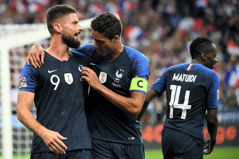 France's forward Olivier Giroud (L) celebrates with teammate France's defender Raphael Varane (C) after scoring a goal during the UEFA Nations League football match between France and Netherlands at the Stade de France stadium, in Saint-Denis, northern of Paris, on September 9, 2018. / AFP PHOTO / FRANCK FIFE