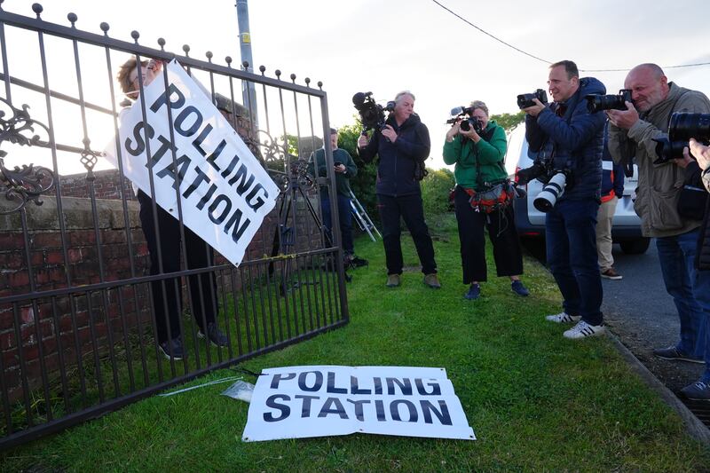 Members of the media photograph a sign outside the polling station in Kirby Sigston, North Yorkshire. PA