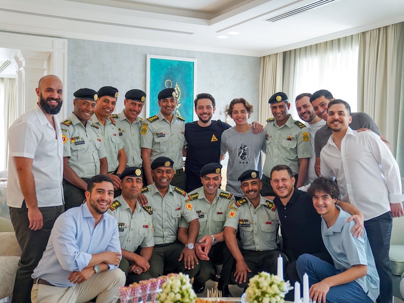 Crown Prince Hussein poses with relatives and colleagues during a traditional pre-wedding ceremony. Reuters